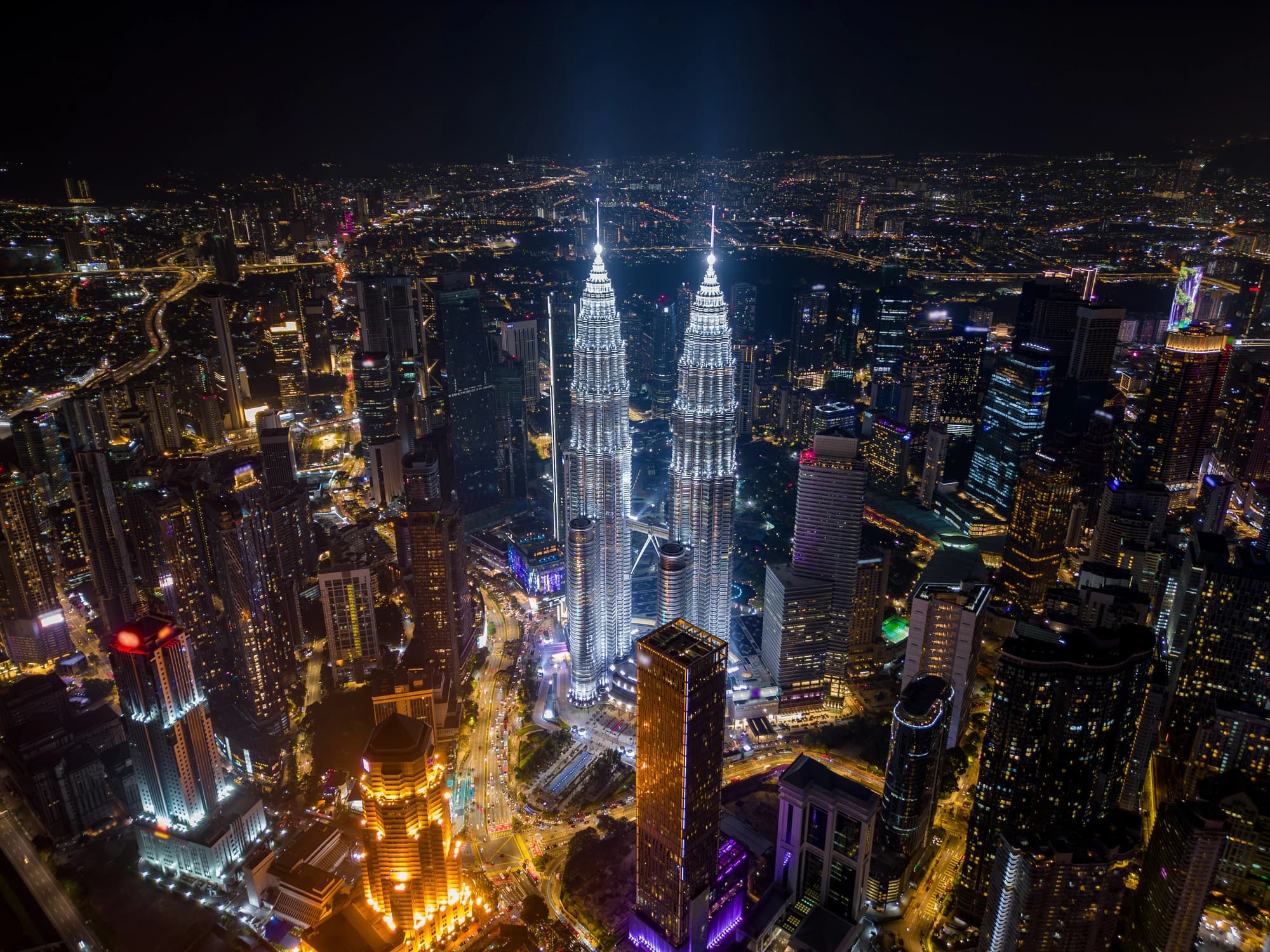 Kuala Lumpur city lights and the KLCC towers seen from above at night